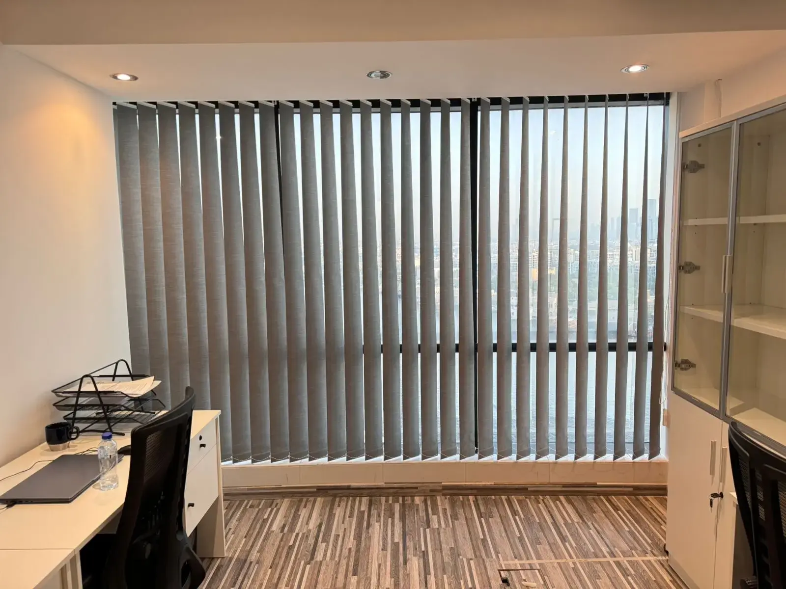 Vertical blinds fitted across a wide window